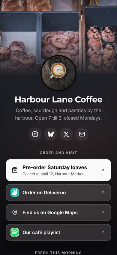 An example café's Link in bio page in the Spotlight theme: a photo background, the café's name, social icons, a large featured Order for pick-up link and website icons on the other links