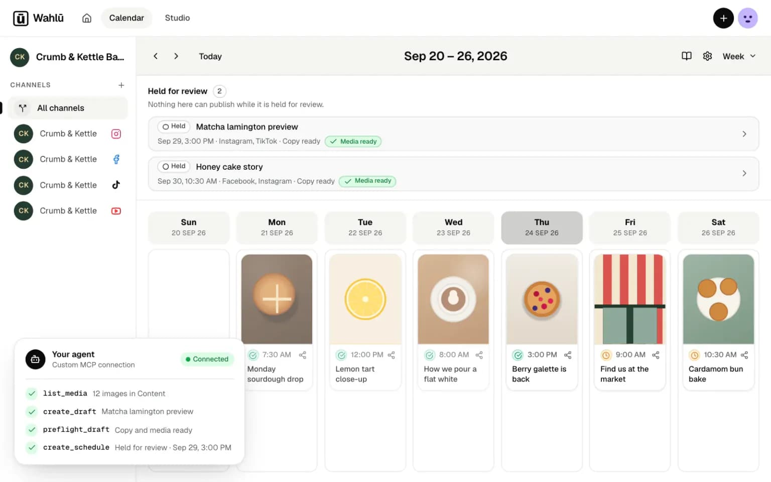 Wahlu week calendar for an example café, with a connected agent creating a draft and a schedule held for review